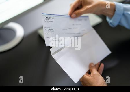 Payroll Cheque In Envelope Stock Photo