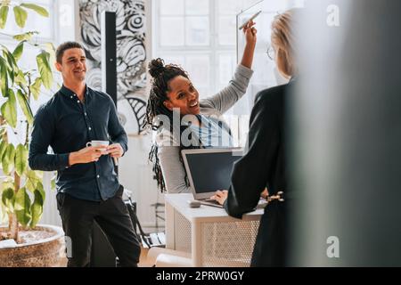 Happy businesswoman with female colleague working on laptop at office Stock Photo