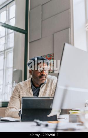 Concentrated businessman working on computer at office Stock Photo