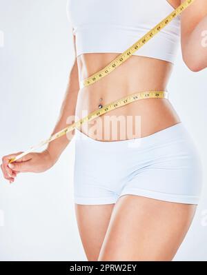 Weight loss, stomach and measure tape for body measurement for health,  wellness and healthy diet. F Stock Photo by YuriArcursPeopleimages