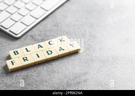 Black friday text and computer keyboard on the gray background. Stock Photo