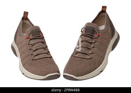 Closeup of a pair of modern brown sneakers or sports shoes isolated on a white background. Elegant and trendy mans shoes. Macro. Stock Photo