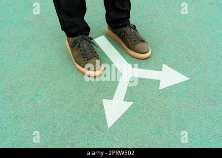 Feet and two arrows painted on blue surface Stock Photo