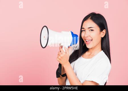 woman teen confident smiling face holding making announcement message shouting screaming in megaphone Stock Photo
