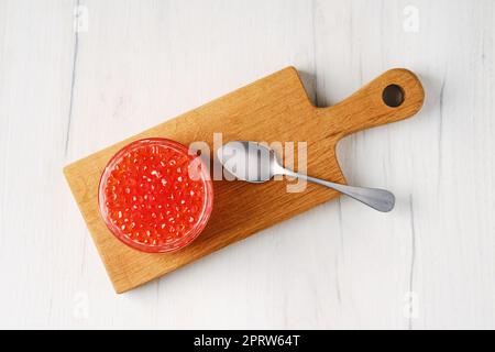 Overhead view of open jar with salmon red caviar Stock Photo