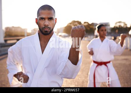 Feel the chi building...Two sportspeople practicing their kata while wearing gi. Stock Photo