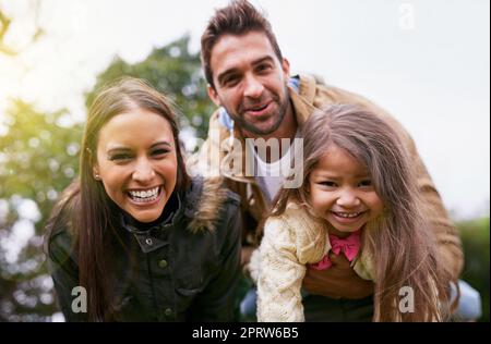 Family over everything. a young family of three enjoying a day in the park. Stock Photo