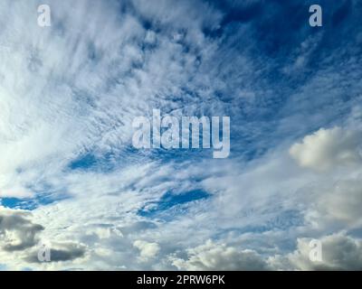 Beautiful fluffy white cloud formations in a deep blue summer sky Stock Photo