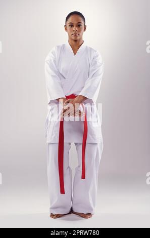 Shes well drilled in her fighting style. a young woman doing karate. Stock Photo