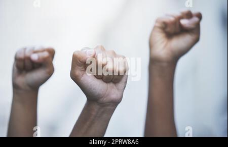 Fist hands to protest, rally and justice from government law, corruption and politics for freedom, power and human rights equality. Crowd of people fight for global revolution, change and stop racism Stock Photo
