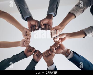 Team, motivation and support with hands fist bump of corporate partnership office workers. Work community, goal success and collaboration hand sign of business employee group teamwork together Stock Photo