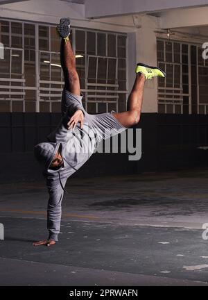 Strength and form. A full length shot of a young man breakdancing. Stock Photo