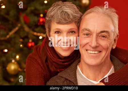 A time for appreciating loved ones. A cropped portrait of a happy senior couple in front of a Christmas tree. Stock Photo