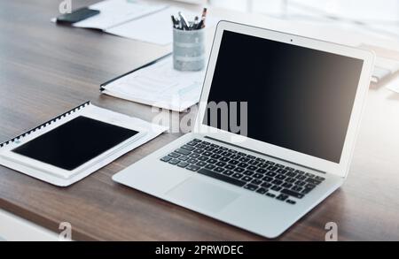Office, laptop and screen on a desk with computer and notebook for new recruit. Table, stationery and an organized setup for productivity at work. Ready to start a new business project at startup Stock Photo