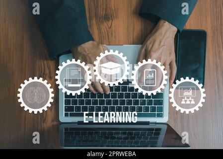 Education online e learning with connected gear icons.Hand using laptop design concept. Top view. Stock Photo