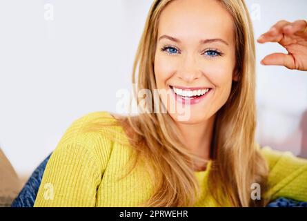 Unwinding at home. a beautiful young woman relaxing at home. Stock Photo