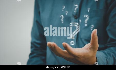 business man icon questions marks on virtual screen at interrogation. Stock Photo