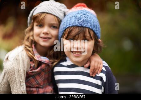 An inseparable pair. Portrait of a cute brother and sister standing outdoors on an autumn day. Stock Photo
