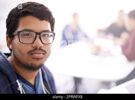 When the going gets tough call a programmer. Portrait of a young employee in a creative office. Stock Photo