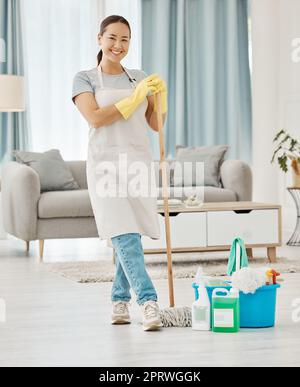 Cleaning floor, house work and woman working in home service mopping living room, doing job with smile and happy to clean house apartment. Portrait of Asian cleaner or housewife housekeeping Stock Photo