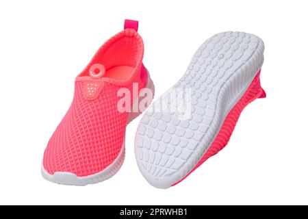 Red sneaker isolated. Close-up of women's trendy athletic shoes or sport sneakers isolated on a white background. Modern footwear design for workout. Macro. Stock Photo