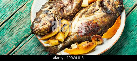 Baked grilled fish in fruit. Stock Photo