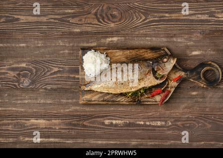 Baked sea yellow tailed lacedra on wooden cutting board Stock Photo