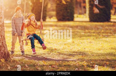 Romantic couple swing in the autumn park Stock Photo - Alamy