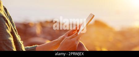 Woman outdoors relaxing with smartphone in her hands. Stock Photo