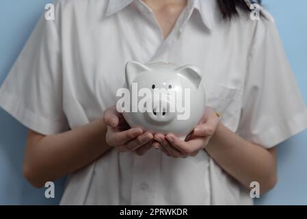 child asian finance economic investment wealth pig currency money business banking, cash success saving girl holding coin piggy bank. Stock Photo