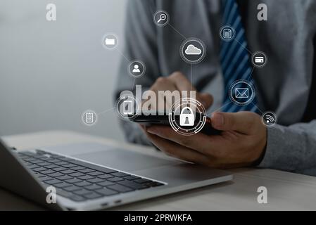 Businessman working with smartphone in hands. Cybersecurity hologram with glowing lock icons on the virtual screen.Business technology internet and networking concept Stock Photo