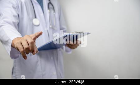 Doctor pressing button on virtual screen on background copy space for text. Stock Photo