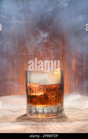 Cocktail with smoked whisky on the lid of barrel Stock Photo
