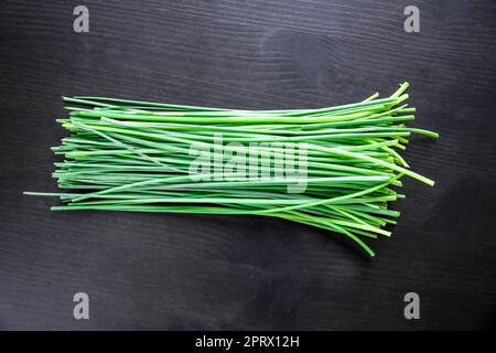 Bunch of chives isolated on black Stock Photo