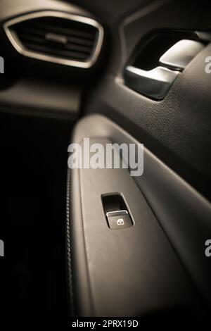 Window lifter button in car door Stock Photo