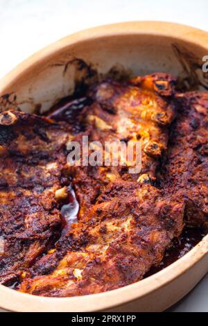 still life of baked ribs in baking plate Stock Photo