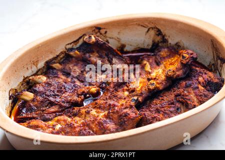 still life of baked ribs in baking plate Stock Photo