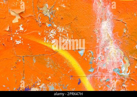 Colorful wall background with damaged paints of orange Stock Photo