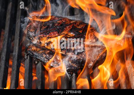 Searing and smoking ribeye steaks on grill Stock Photo
