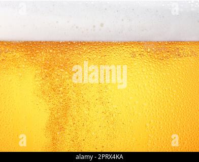 Close up background of beer with bubbles in glass Stock Photo