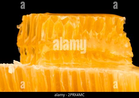 Fresh cut comb honey isolated on black Stock Photo