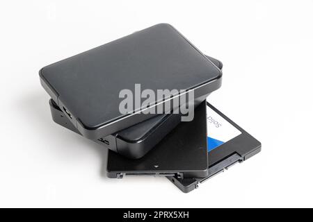 A stack of external USB hard drives on a white background. Stock Photo