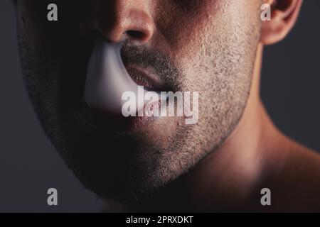 Smoke, black man and face marijuana with cancer awareness and with bad habit with black studio background. Addiction, mouth with smoking cloud and mal Stock Photo