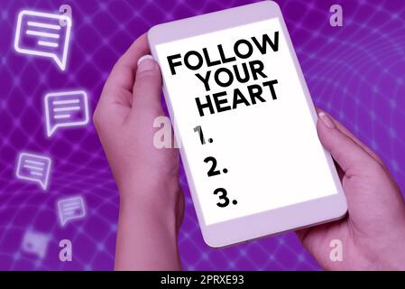 Hand writing sign Follow Your Heart, Word for Motivation to do what is right and fulfill your desire Stock Photo