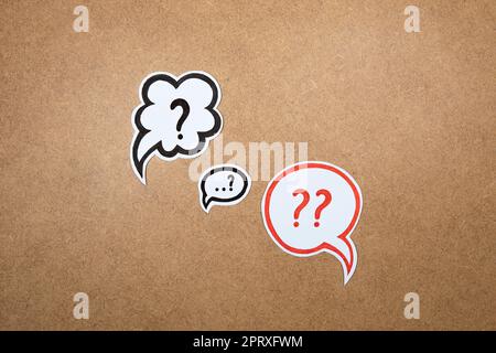 Question marks in speech bubbles. Paper shape of bubble with hand drawn interrogation points. Question concept, important information, dispute, hesita Stock Photo