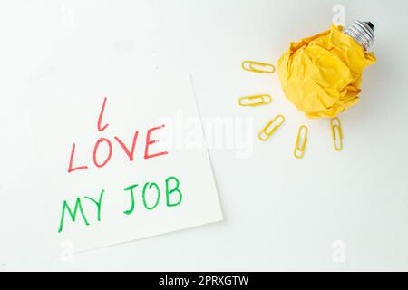 top view idealight bulb gem clips i love my job written on paper on white background Stock Photo