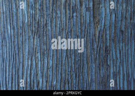 Textured natural indigo coating, with vertical pattern of uneven stripes. Colored background. Modern wallpaper and plaster. Use of natural materials Stock Photo
