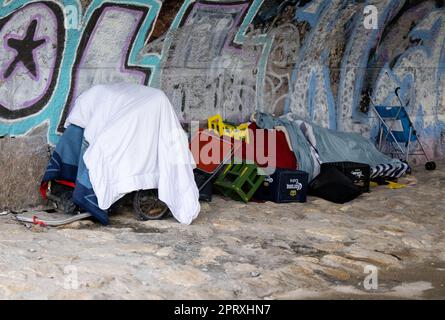 Munich, Germany. 27th Apr, 2023. The belongings of a homeless man lie on the bank of the Isar River under a bridge. Credit: Sven Hoppe/dpa/Alamy Live News Stock Photo