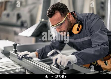 Wood turners measure and calculate the right size of workpiece dimension using hand and power tools. Cut, shape, rotate, smooth, and balance wood fixt Stock Photo