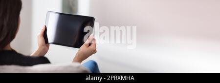 Woman Using Digital Tablet At Home. Holding Blank Touchscreen Stock Photo